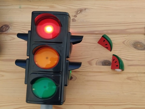 A traffic light, and a watermelon