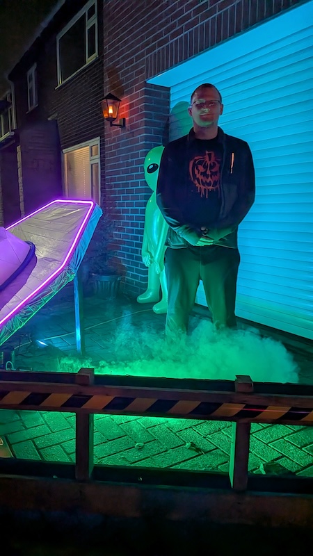 A picture of myself, taken by my younger son. I am standing behind the UFO, next to the inflatable aliens.