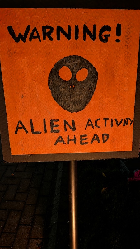 Close-up view of the Aliens Ahead warning sign.